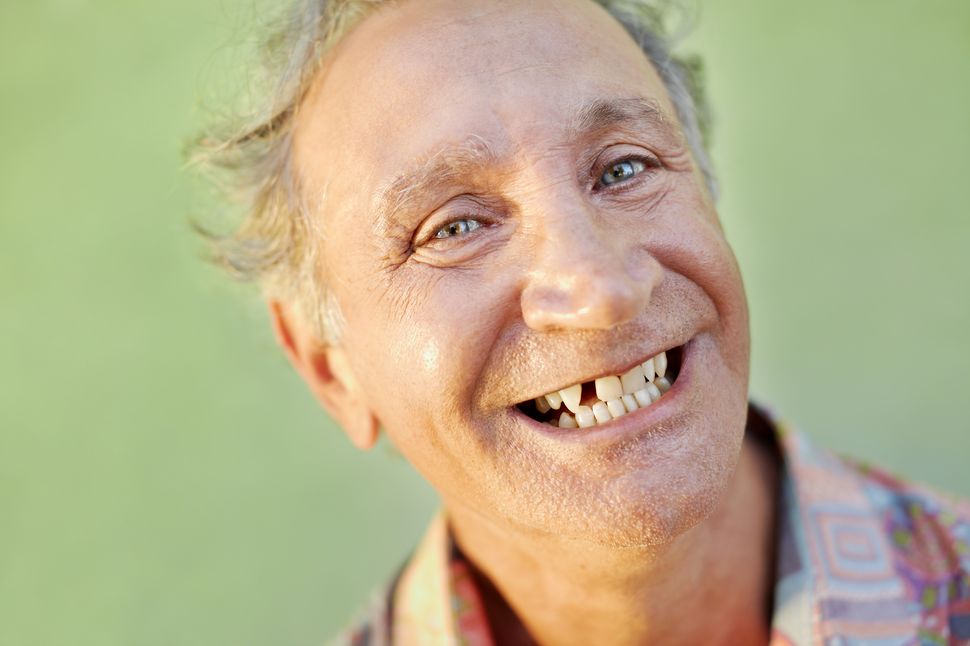portrait of senior caucasian man with dental problems showing missing tooth and smiling. Horizontal shape, copy space